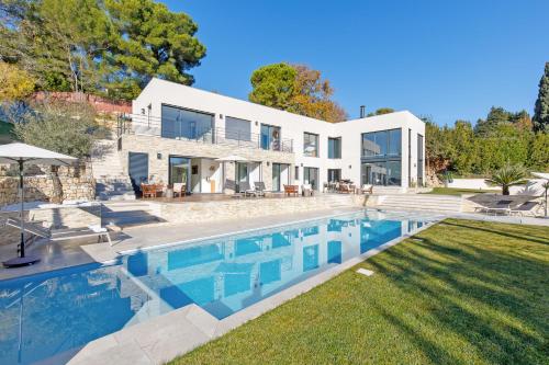 an exterior view of a house with a swimming pool at Villa SOHA Bed & Breakfast in Mougins