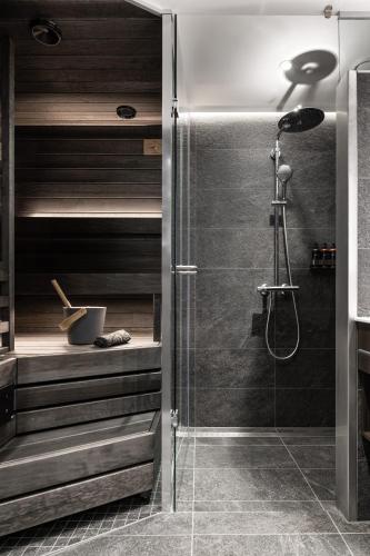 a bathroom with a shower with a glass door at Lapland Hotels Arena in Tampere