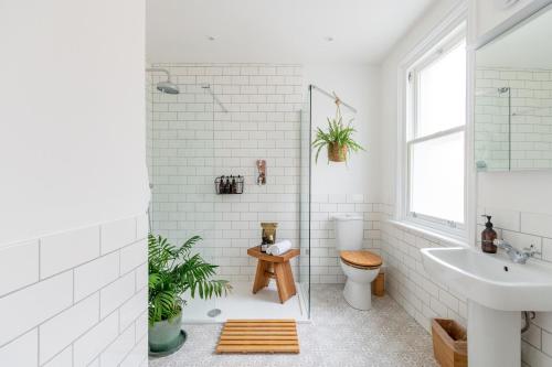 a white bathroom with a sink and a toilet at Doghouse Margate in Kent