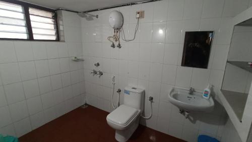 トリバンドラムにあるRitu Homestayのバスルーム(トイレ、洗面台付)