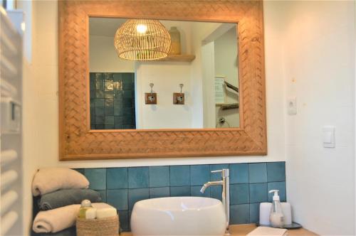 bagno con lavandino e specchio di L'Abri du Marin ad Audierne