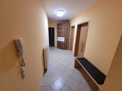 a hallway of a room with a phone on the wall at Familienfreundliche Fewo MV Malchin in Malchin