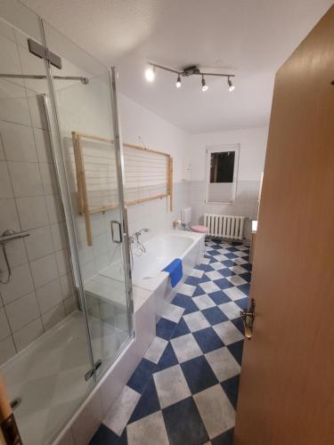 a bathroom with a shower and a bath tub at Familienfreundliche Fewo MV Malchin in Malchin
