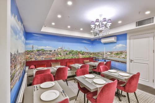 a restaurant with red chairs and tables and a view at 9 Doors Hotel in Istanbul