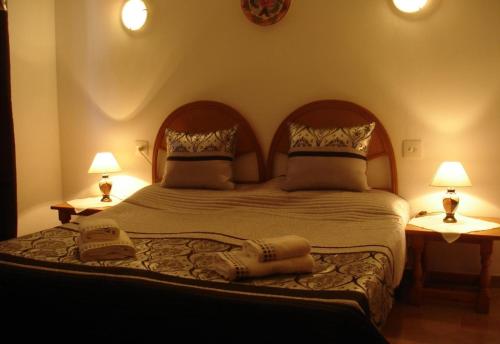 a bedroom with a large bed with two lamps at Casa in Calpe Carrio Park in Calpe