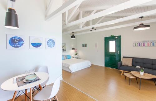 a room with a bed and a table and a couch at Ligia Waterfront Apartments in Lygia