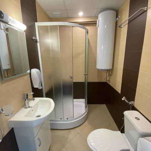 a bathroom with a shower and a toilet and a sink at КОМПЛЕКС ОКЕЙ in Shumen