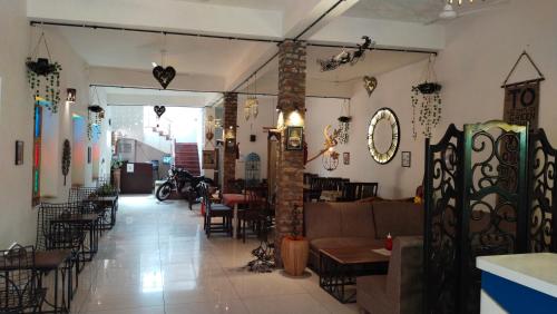 a restaurant with tables and chairs in a room at RANGBAARI STAYS & CAFE in Jodhpur