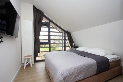 Un pat sau paturi într-o cameră la Duinroos Egmond