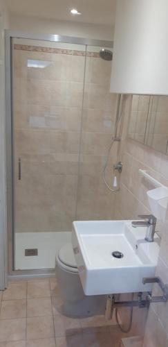 a bathroom with a shower and a sink and a toilet at Silent Bay Apartments in Sestri Levante