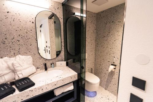 a bathroom with a sink and a mirror at Boutique Hotel Edelweiss in Sankt Anton am Arlberg