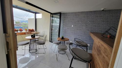 a room with two tables and chairs in a room at Hotel Piedras De Maní in Manizales