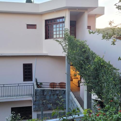 an external view of a white house with a staircase at Pousada Solar Do Triunfo in Triunfo