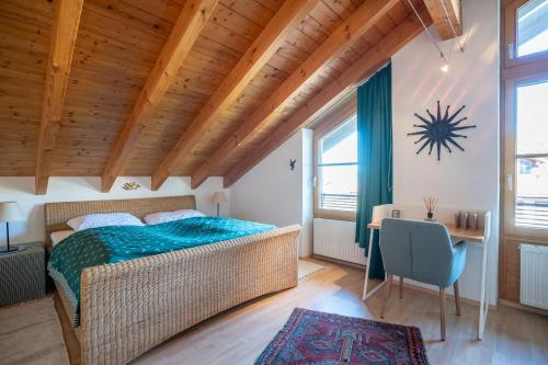 a bedroom with a bed and a table and a desk at Mein Lieblingsort in Burgberg