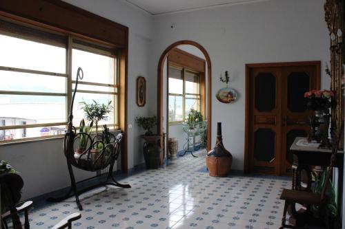 a room with a table and chairs and a door at Casa Prunilla in Sarno