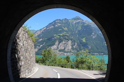a view of a mountain from a round window at Hotel Urirotstock in Isenthal