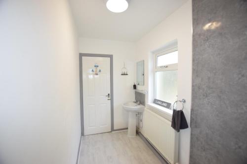 a bathroom with a sink and a toilet and a window at 1 Bedroom Holiday let in the Heart of West Wales in Carmarthen