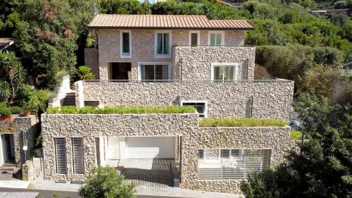 an image of a house with a stone wall at VILLA LE MANDRIE 7&2, Emma Villas in Castiglione della Pescaia