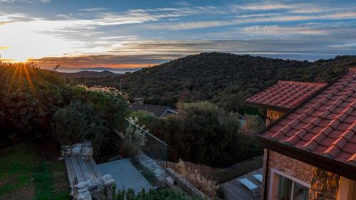 a house with a view of a mountain at VILLA LE MANDRIE 7&2, Emma Villas in Castiglione della Pescaia