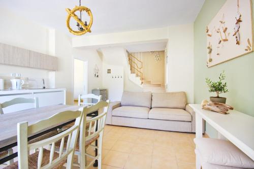 a kitchen and living room with a couch and a table at Thassian Villas in Limenas