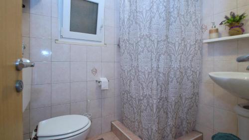 a bathroom with a toilet and a sink at Apartment Slatina Bay in Vela Luka