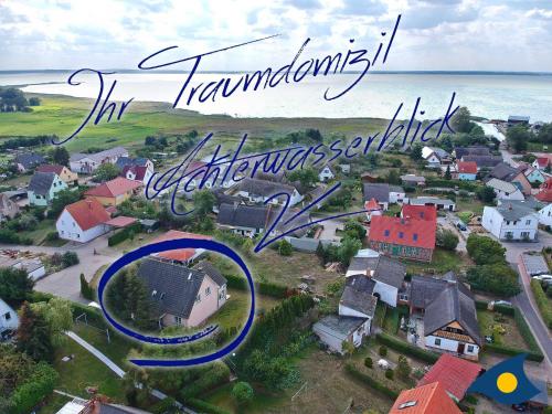 an aerial view of a small town with the ocean at Haus Achterwasserblick in Ueckeritz