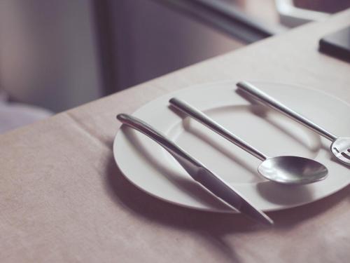 a white plate with two spoons on a table at Holiday Inn Express Newport by IHG in Newport