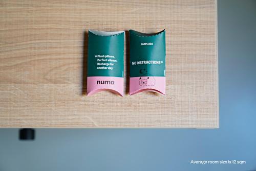 two books sitting on top of a wooden table at Numa Madrid Script in Madrid