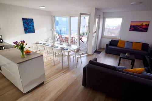 a living room with a table and a dining room at Villa Miri II in Privlaka
