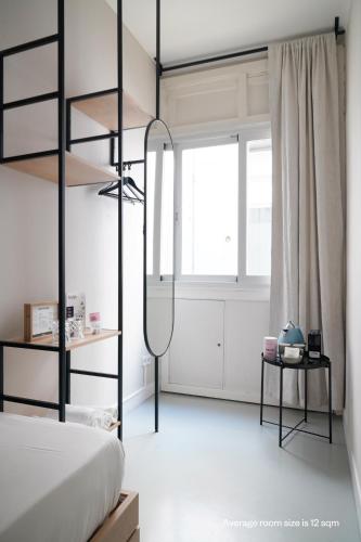 a bedroom with a black bunk bed and a window at Numa Madrid Script in Madrid