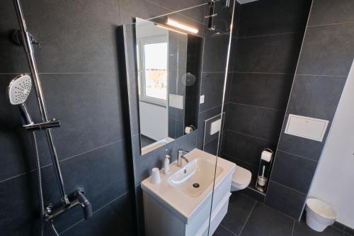 a bathroom with a sink and a mirror at Villa Miri II in Privlaka