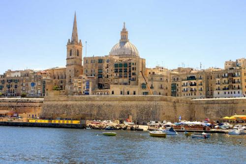 a view of a city with boats in the water at Il Palazzin Hotel in St Paul's Bay