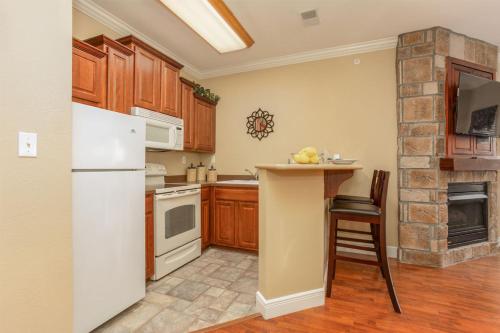 a kitchen with a white refrigerator and a counter at Great Rock Resort at Branson in Branson