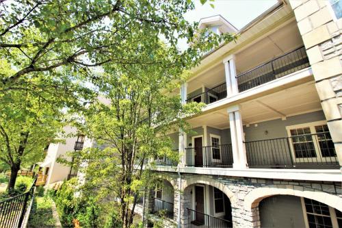an apartment building with balconies and trees at Great Rock Resort at Branson in Branson
