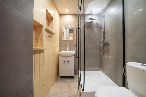 a bathroom with a shower and a toilet and a sink at Zielony domek nad Marychą w Budwieć in Stanowisko