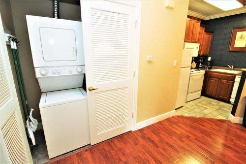 a kitchen with a white refrigerator in a room at Great Rock Resort at Branson in Branson