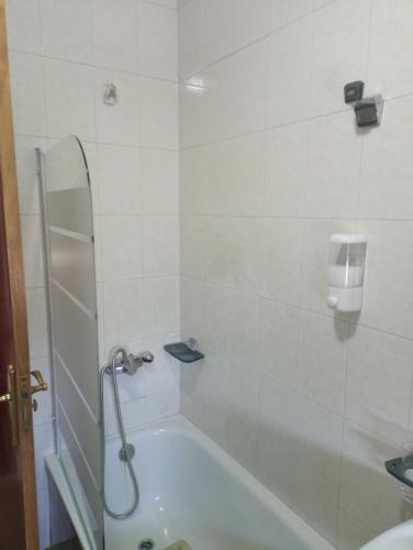 a bathroom with a shower and a bath tub at O novo alto do couso in Ourense
