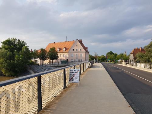 a bridge over a road with a sign on a fence at Fado Apartments Gornja Radgona in Gornja Radgona