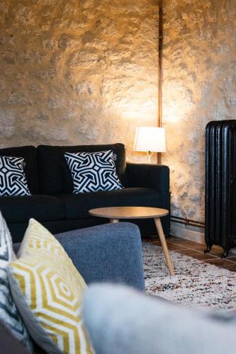 a living room with a couch and a table at Le Mas Réolais in Saint-Sève