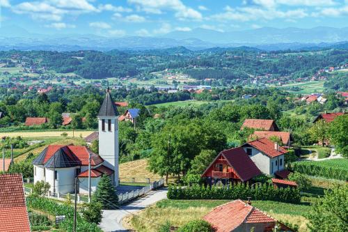 an aerial view of a small village with a church at Kuća za odmor Rukova Hiža in Donja Stubica