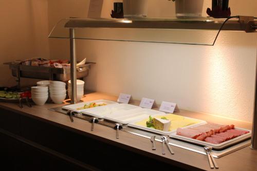 a buffet with a plate of food on a table at RheinHotel ARTE in Remagen