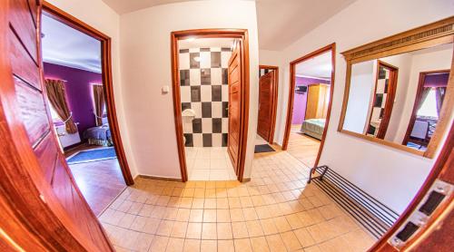 a hallway with a walk in shower in a house at Borhotel Sziluett Farkasmály in Gyöngyös