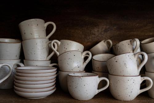 a pile of white cups and saucers on a table at Petit Palace Preciados in Madrid