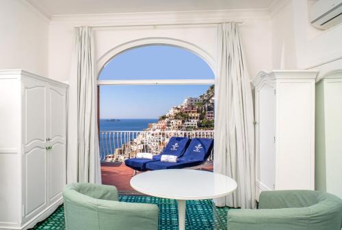 a room with two chairs and a table and a window at Villa Fiorentino in Positano