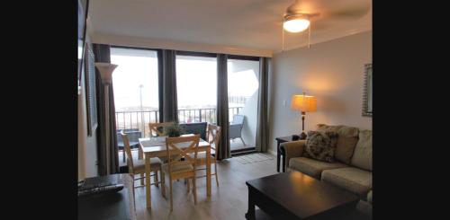 a living room with a couch and a table at Gulf Shores Island Winds East #103, Gulf Front. Closest building to Hangout! in Gulf Shores