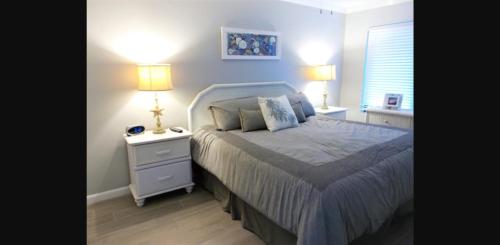 a bedroom with a bed and a nightstand with two lamps at Gulf Shores Island Winds East #103, Gulf Front. Closest building to Hangout! in Gulf Shores
