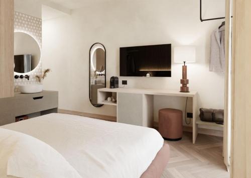 
a hotel room with a bed and a television at Hotel Querceto Wellness & Spa in Malcesine
