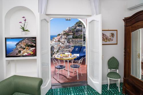 a room with a balcony with a view of a city at Villa Fiorentino in Positano