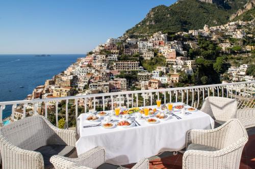 a table with food on a balcony overlooking the amalfi coast at Villa Fiorentino in Positano
