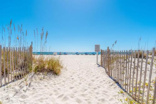 a sandy beach with a fence at Gulf Shores Island Winds East #103, Gulf Front. Closest building to Hangout! in Gulf Shores